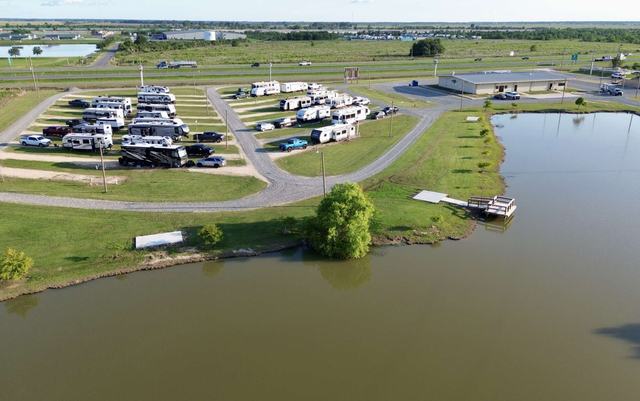 Aerial view of American Dream RV Park with RVs parked beside a large pond