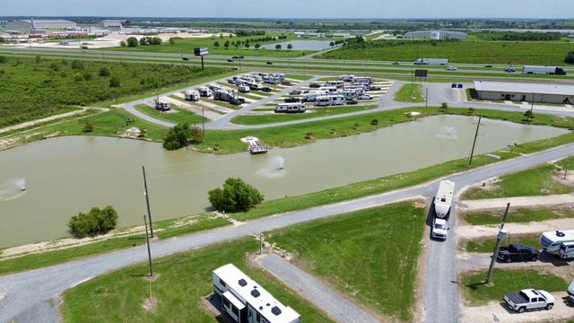 Aerial view of American Dream RV Park pond with fountains and RV sites beyond