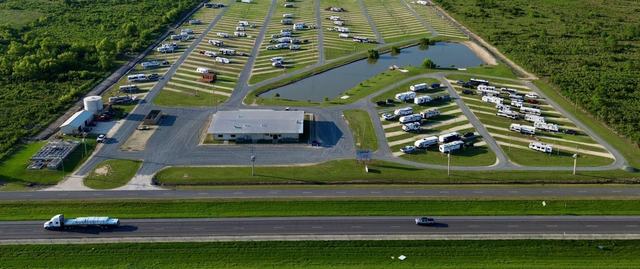 Wide aerial view of American Dream RV Park beside a highway with passing truck