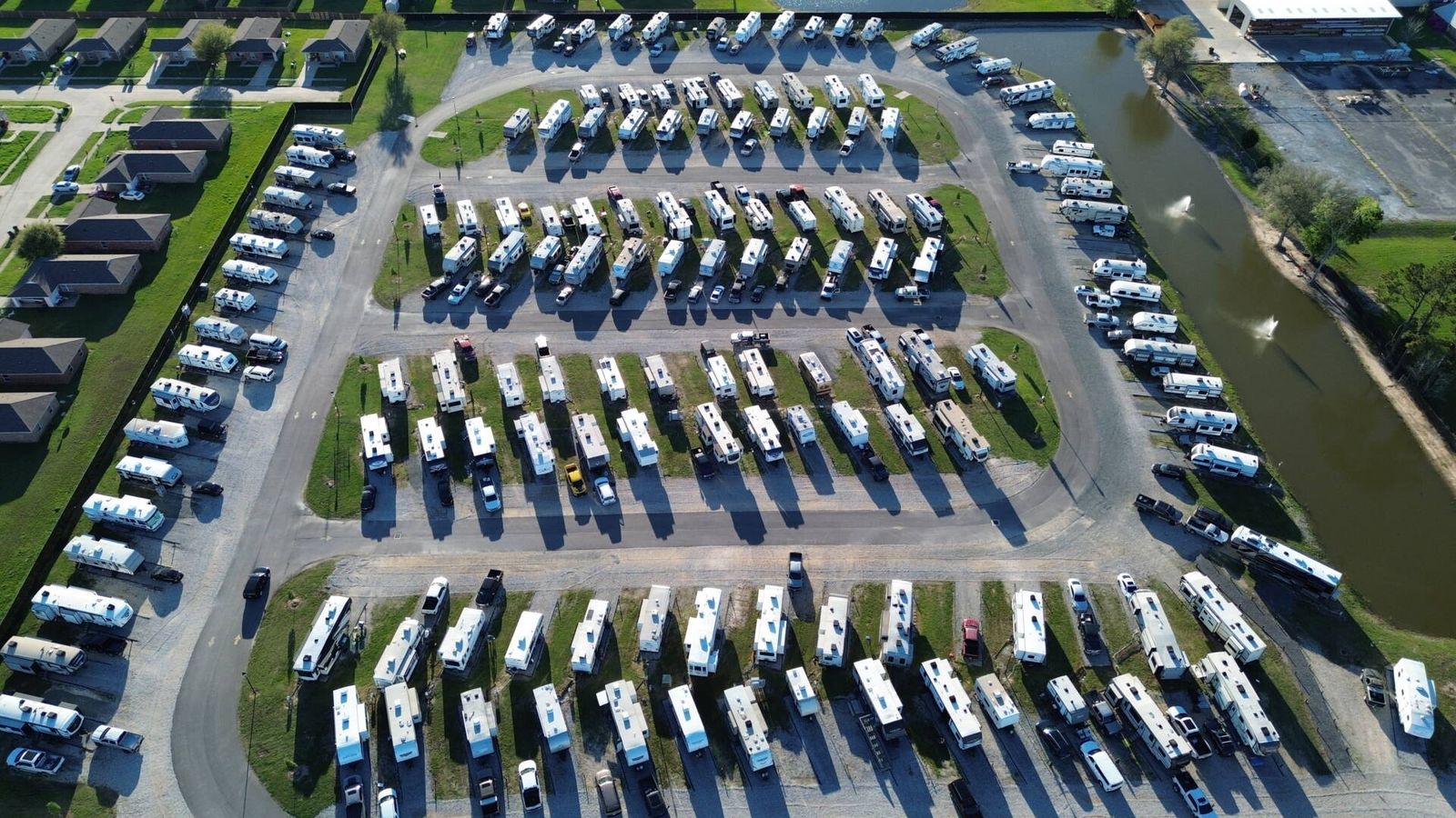 Overhead aerial view of The Gates at McNeese RV Park rows beside a canal with fountains