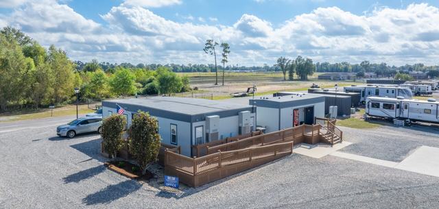 Aerial view of the office building with wooden ramp and landscaping near parked RVs