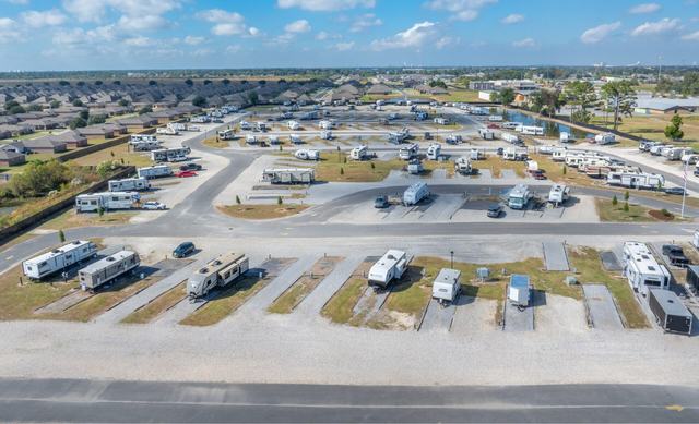 Aerial view of The Gates at McNeese RV Park with paved sites and nearby homes
