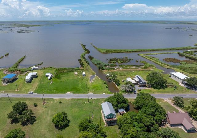 Aerial view of Pecan Island Camp across the road from waterfront lots and lake