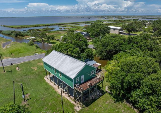 Aerial view of Pecan Island Camp green house with metal roof and deck