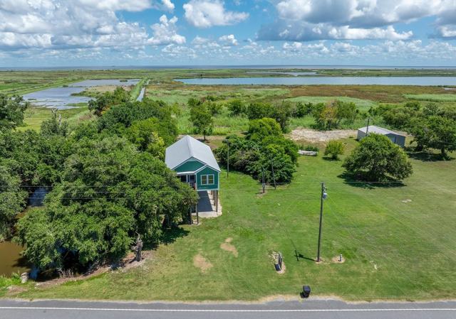 Aerial view of Pecan Island Camp house and large grassy lot near road