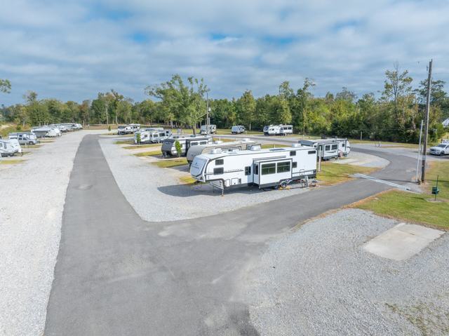 Elevated view of Rustic Oak RV Park with RVs on gravel sites along paved road