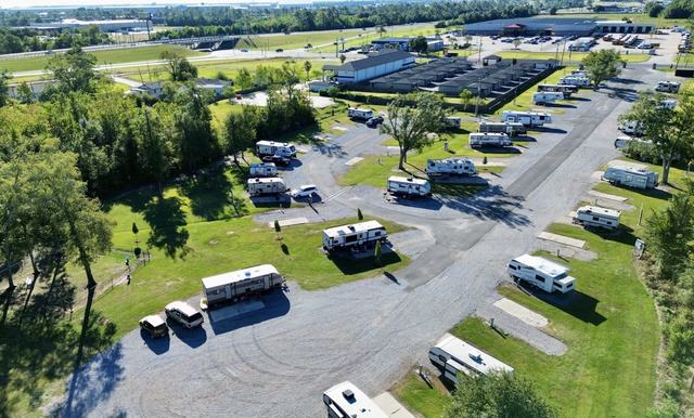 Aerial view of Rustic Oak RV Park with RVs on sites along paved roads